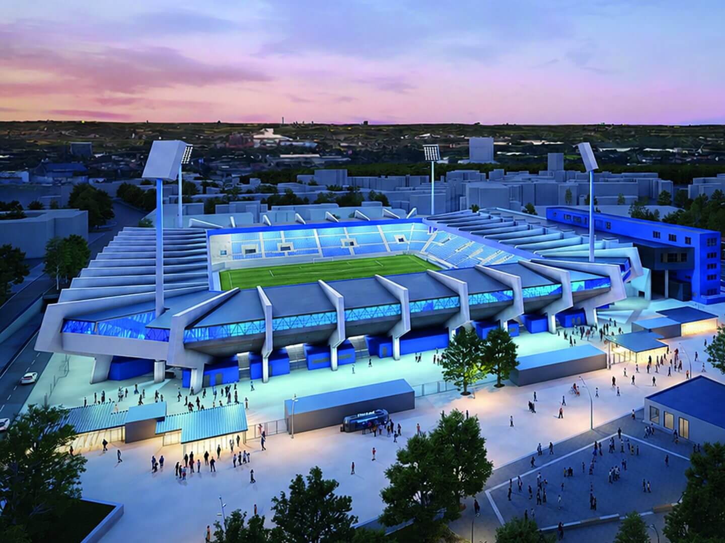 Das beleuchtete Vonovia Ruhrstadion bei Dämmerung mit Zuschauern im Außenbereich.