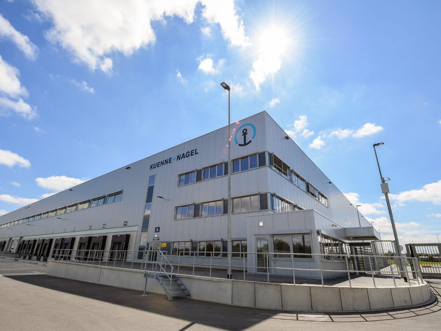 Außenansicht des Kühne + Nagel Logistikzentrums bei Sonnenschein in Luxemburg.