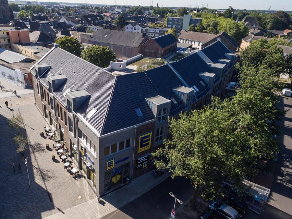 Luftaufnahme eines modernen Wohn- und Geschäftshauses mit Edeka-Markt am Kesselsturm in Viersen-Dülken.